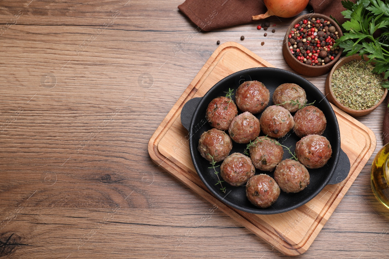 Photo of Tasty cooked meatballs on wooden table, flat lay, Space for text
