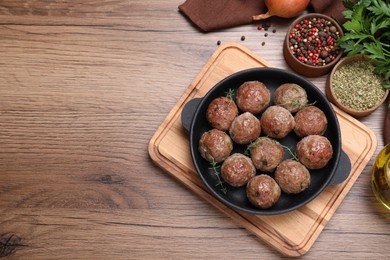 Tasty cooked meatballs on wooden table, flat lay, Space for text