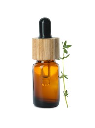 Bottle of essential oil and thyme isolated on white