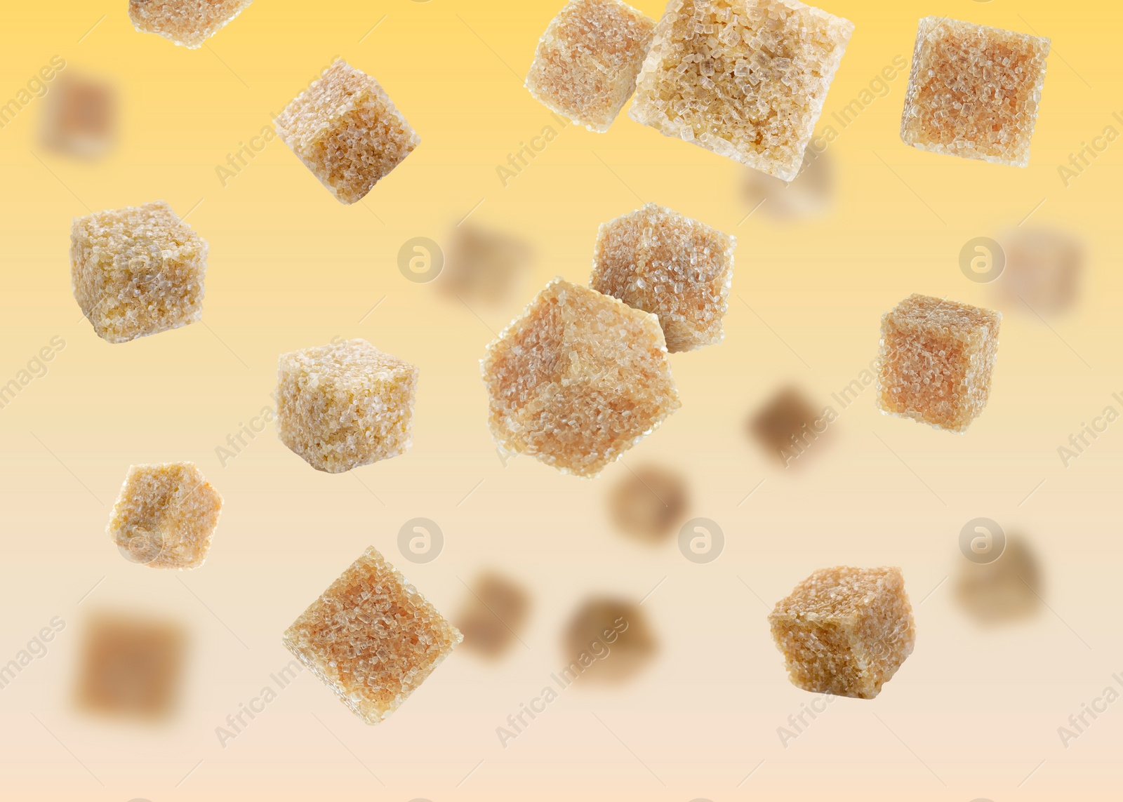 Image of Brown cane sugar cubes falling on golden gradient background