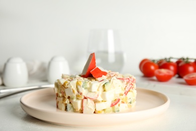 Photo of Delicious salad with fresh crab sticks on white table
