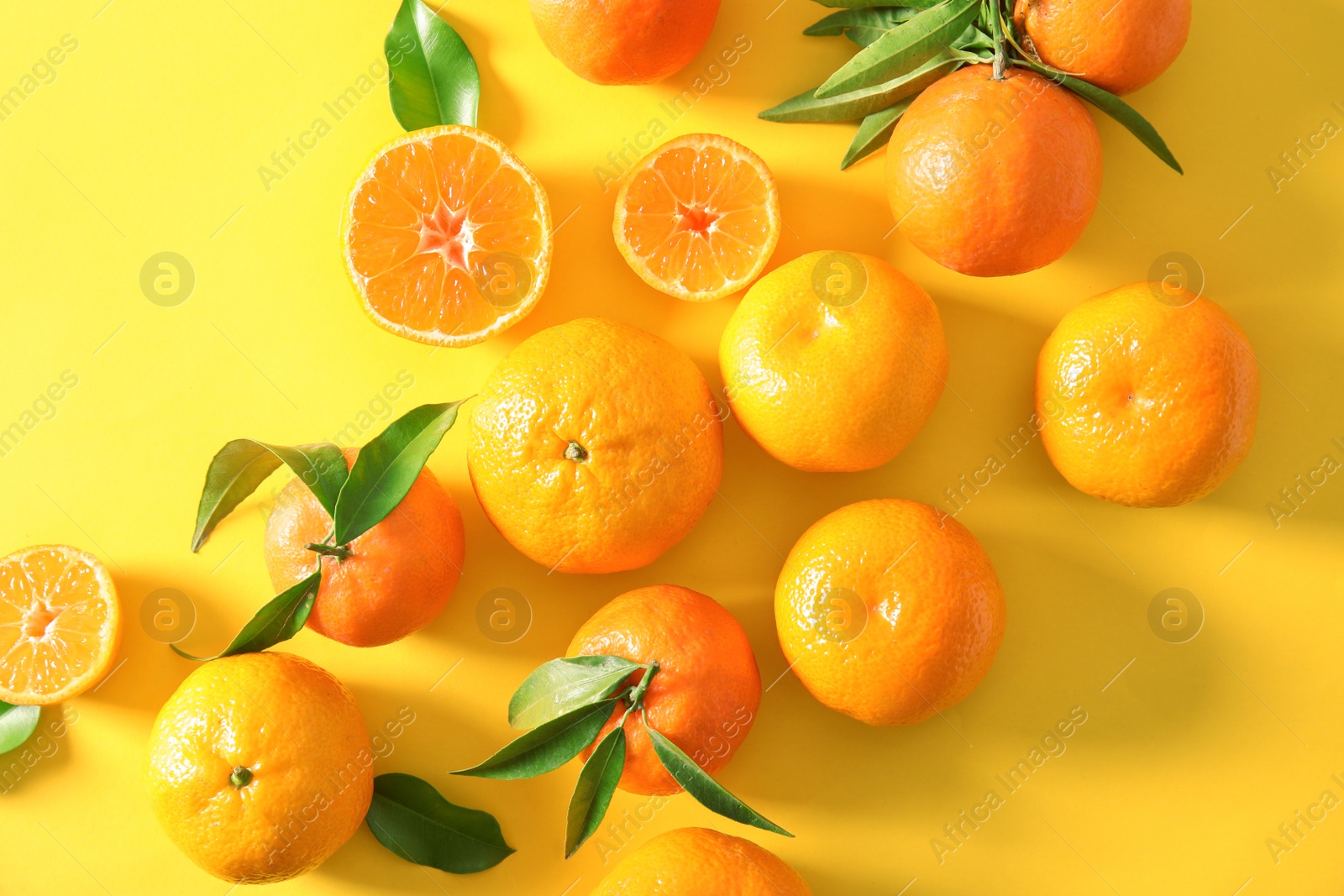 Photo of Flat lay composition with ripe tangerines on color background