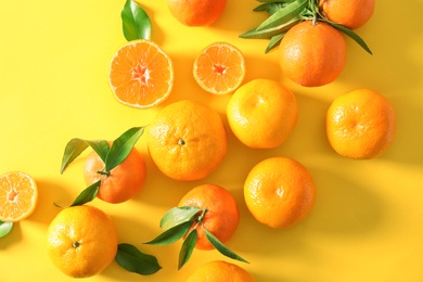 Flat lay composition with ripe tangerines on color background