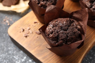 Tasty chocolate muffins on grey table, closeup