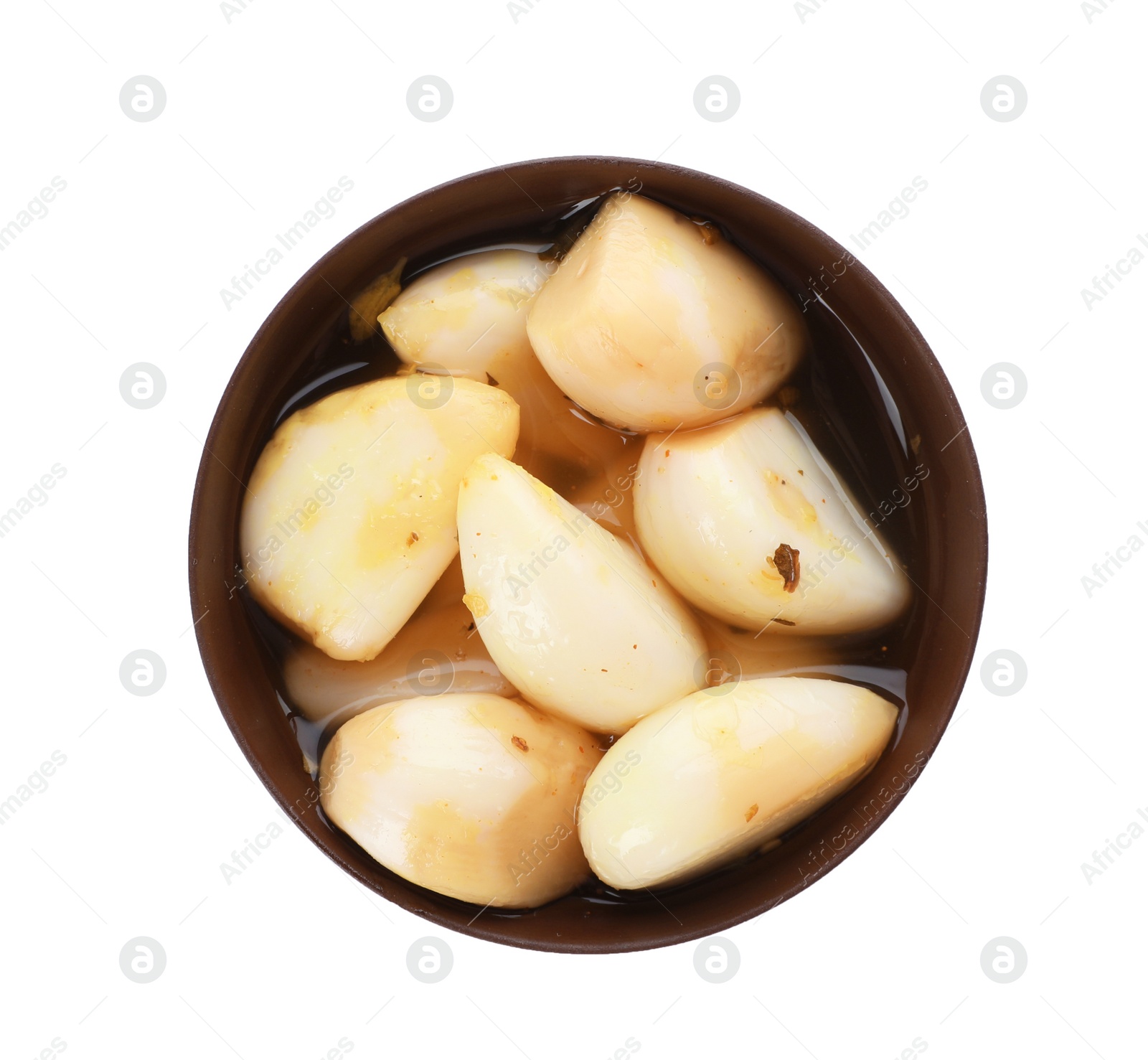 Photo of Bowl with preserved garlic on white background, top view