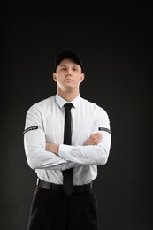 Photo of Male security guard in uniform on dark background