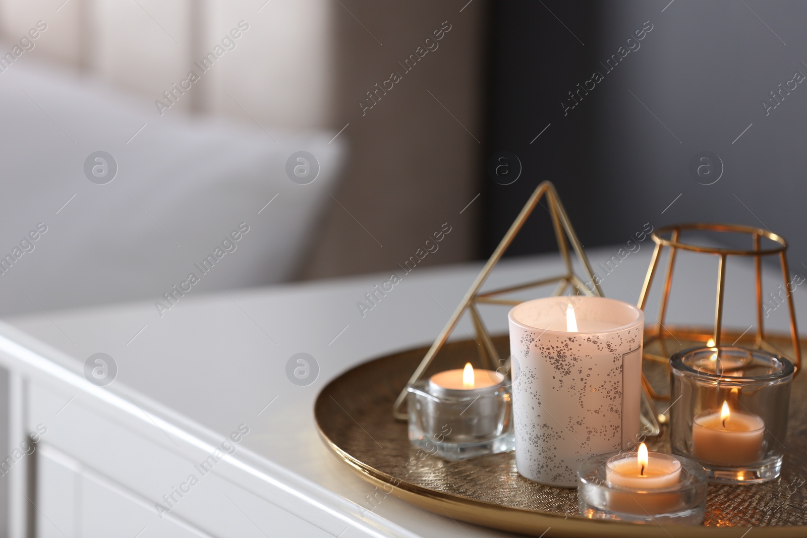 Photo of Beautiful burning candles and decor on table at home. Space for text