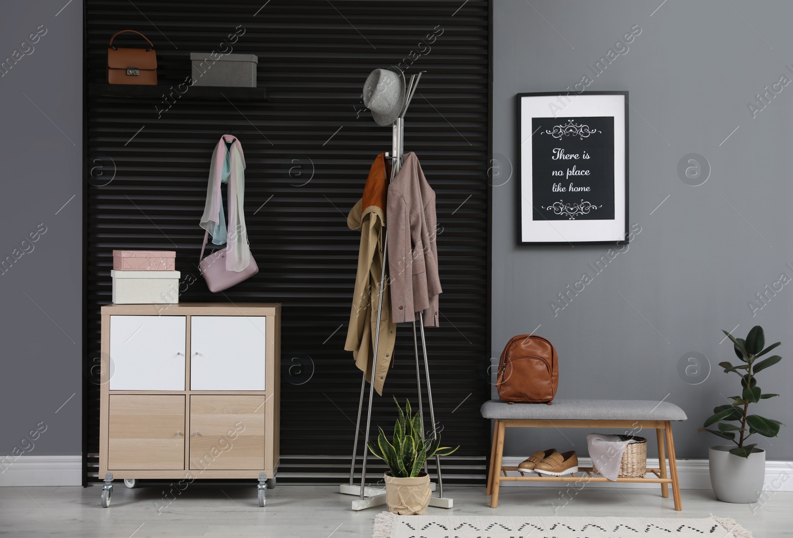 Photo of Hallway interior with stylish furniture, clothes and accessories