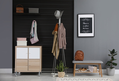 Hallway interior with stylish furniture, clothes and accessories