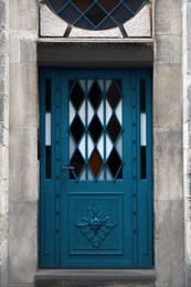 Photo of View of building with blue leaded glass door. Exterior design
