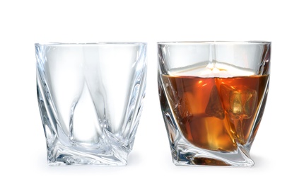 Empty and full whiskey glasses on white background