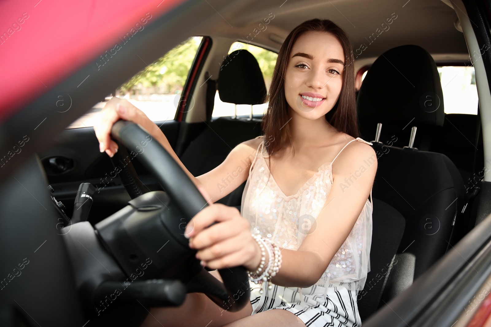 Photo of Young woman on driver's seat of car