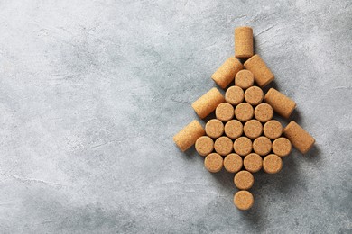 Christmas tree made of wine corks on grey table, top view. Space for text