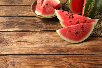 Photo of Delicious fresh watermelon slices on wooden table. Space for text