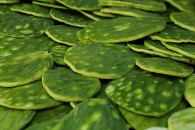 Heap of fresh nopal leaves as background, closeup