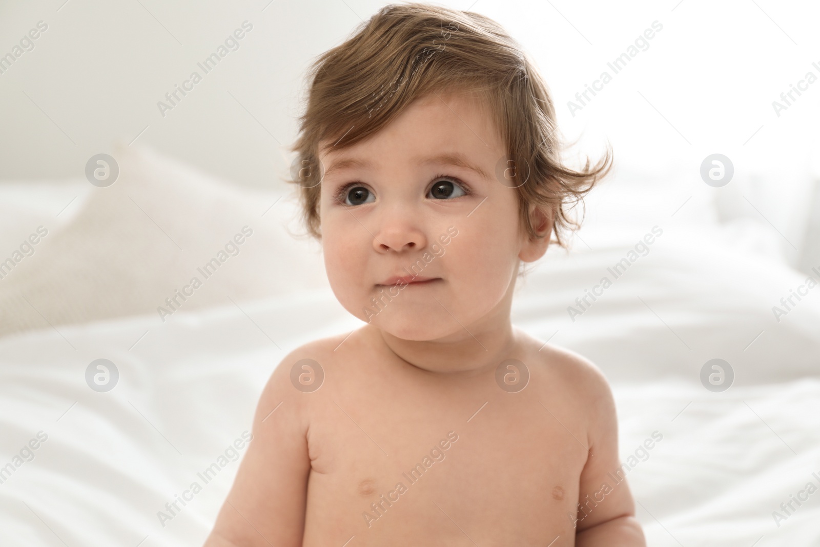 Photo of Adorable little baby on bed. Cute child