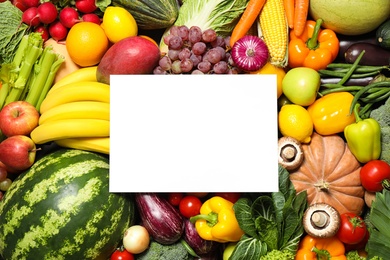 Photo of Blank card with assortment of organic fresh fruits and vegetables as background, top view. Space for text