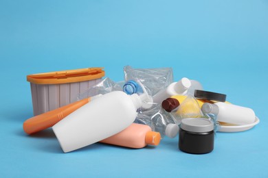Photo of Pile of plastic garbage on light blue background