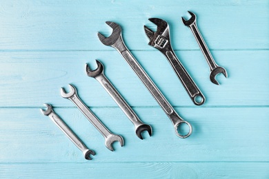 New wrenches on color background, top view. Plumber tools