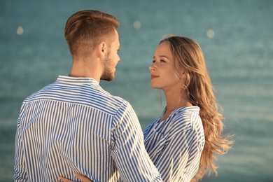 Happy young couple resting together on beach