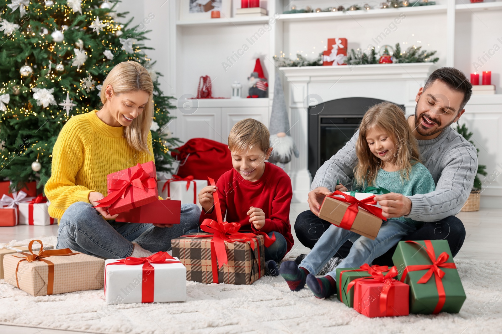 Photo of Happy family with Christmas gifts at home