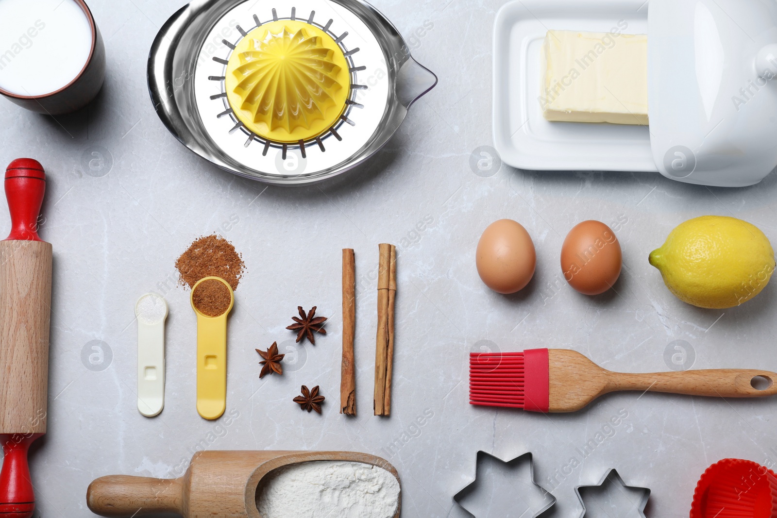 Photo of Cooking utensils and ingredients on light marble table, flat lay