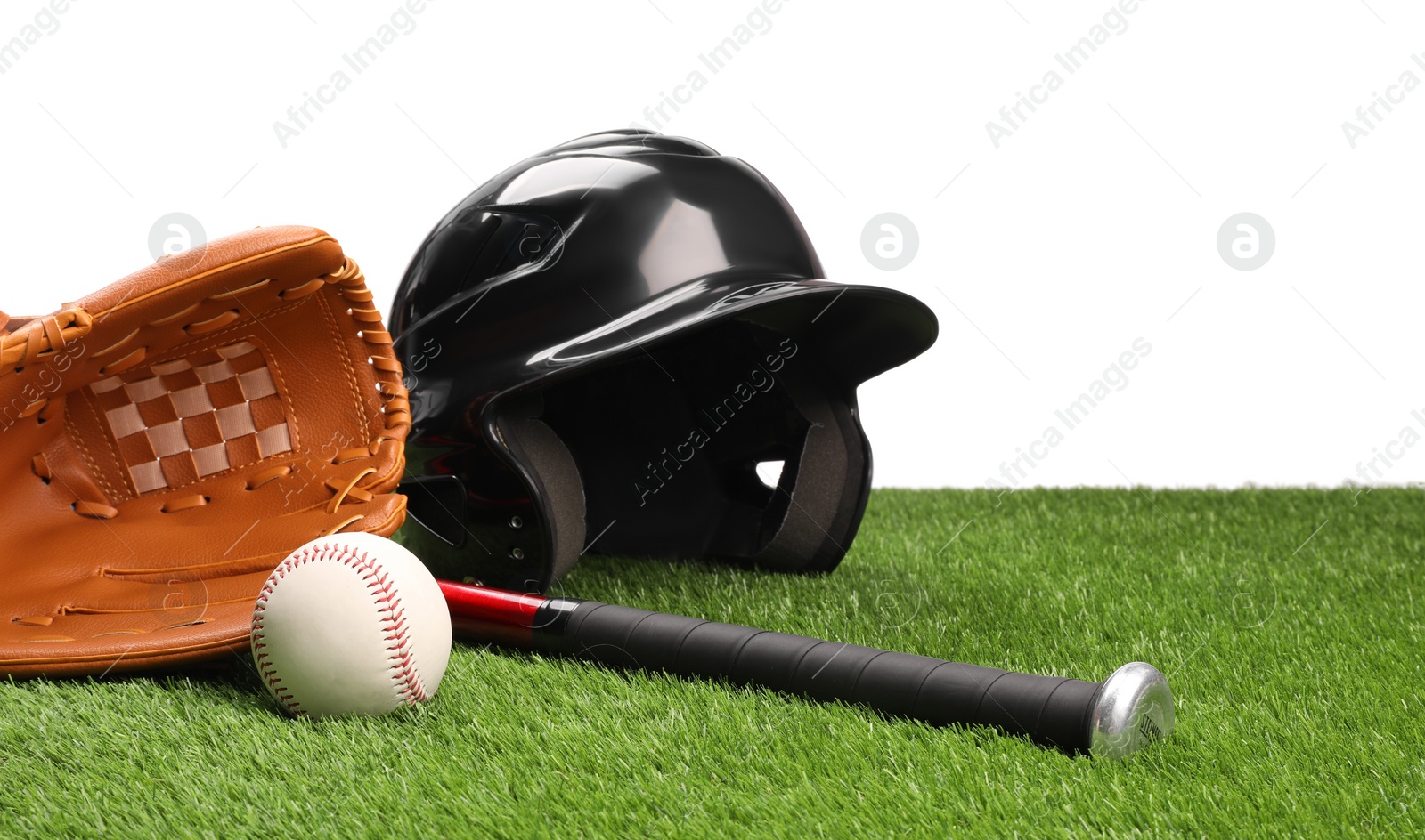 Photo of Baseball bat, ball, batting helmet and glove on artificial grass against white background