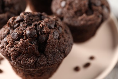 Delicious fresh chocolate muffins on table, closeup. Space for text