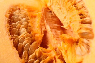 Photo of Cut fresh ripe pumpkin with seeds as background, closeup