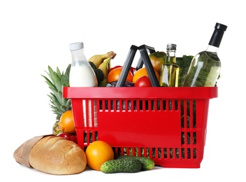 Photo of Shopping basket and grocery products on white background