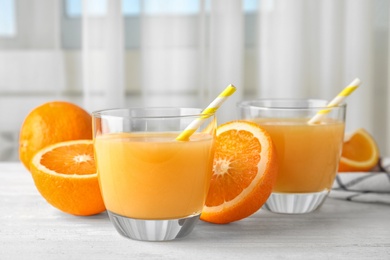 Photo of Composition with orange juice and fresh fruit on table