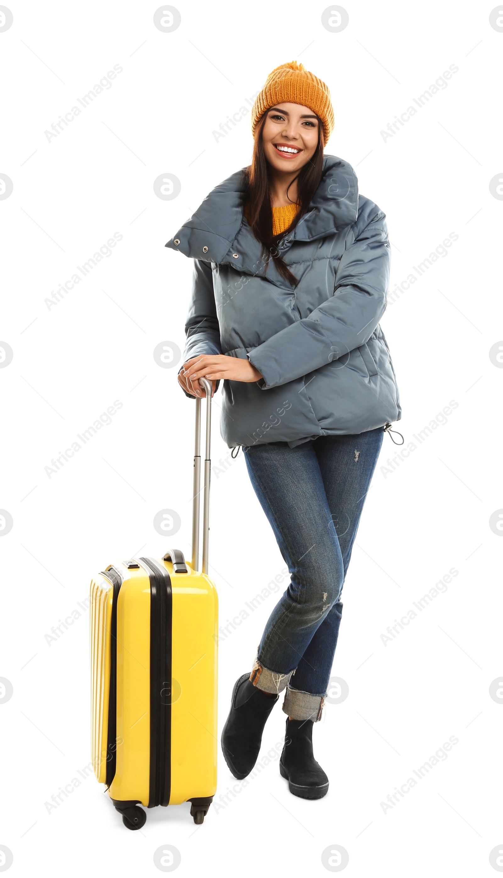 Photo of Young woman in warm clothes with suitcase on white background. Winter vacation