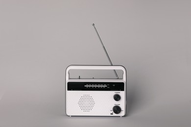 Photo of Portable retro radio receiver on grey background