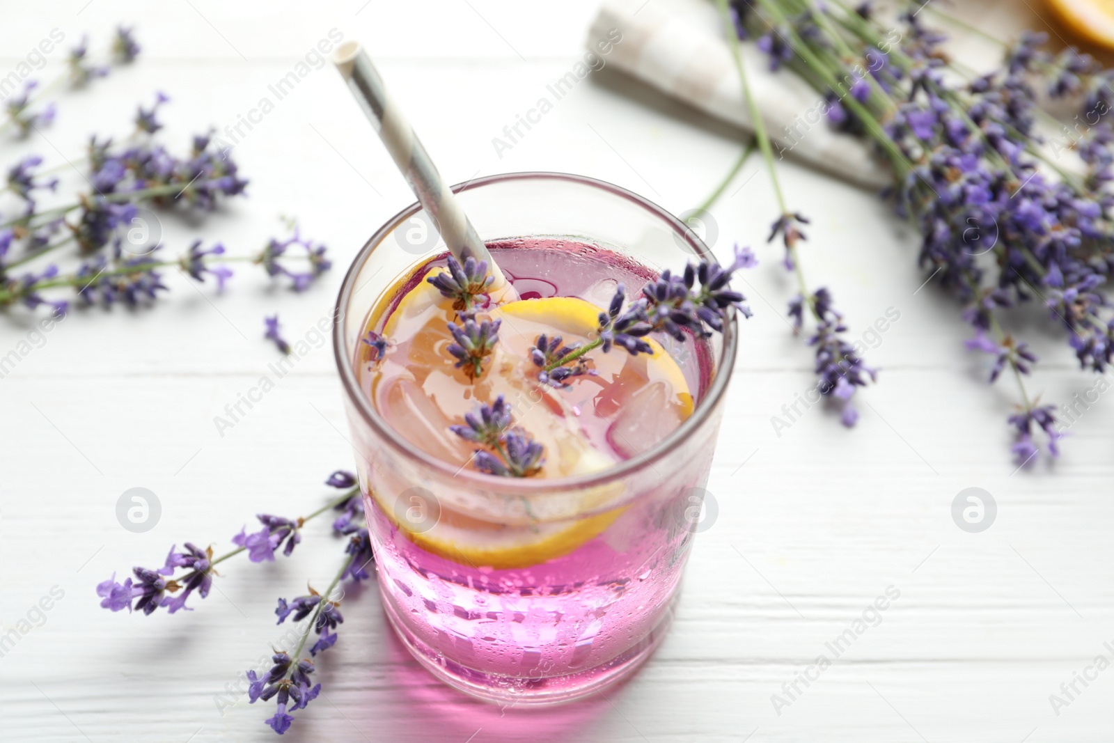 Photo of Fresh delicious lemonade with lavender on white wooden table