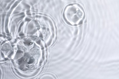 Photo of Closeup view of water with circles on light background