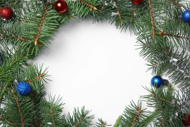 Frame made with Christmas decor on white background, top view. Space for text