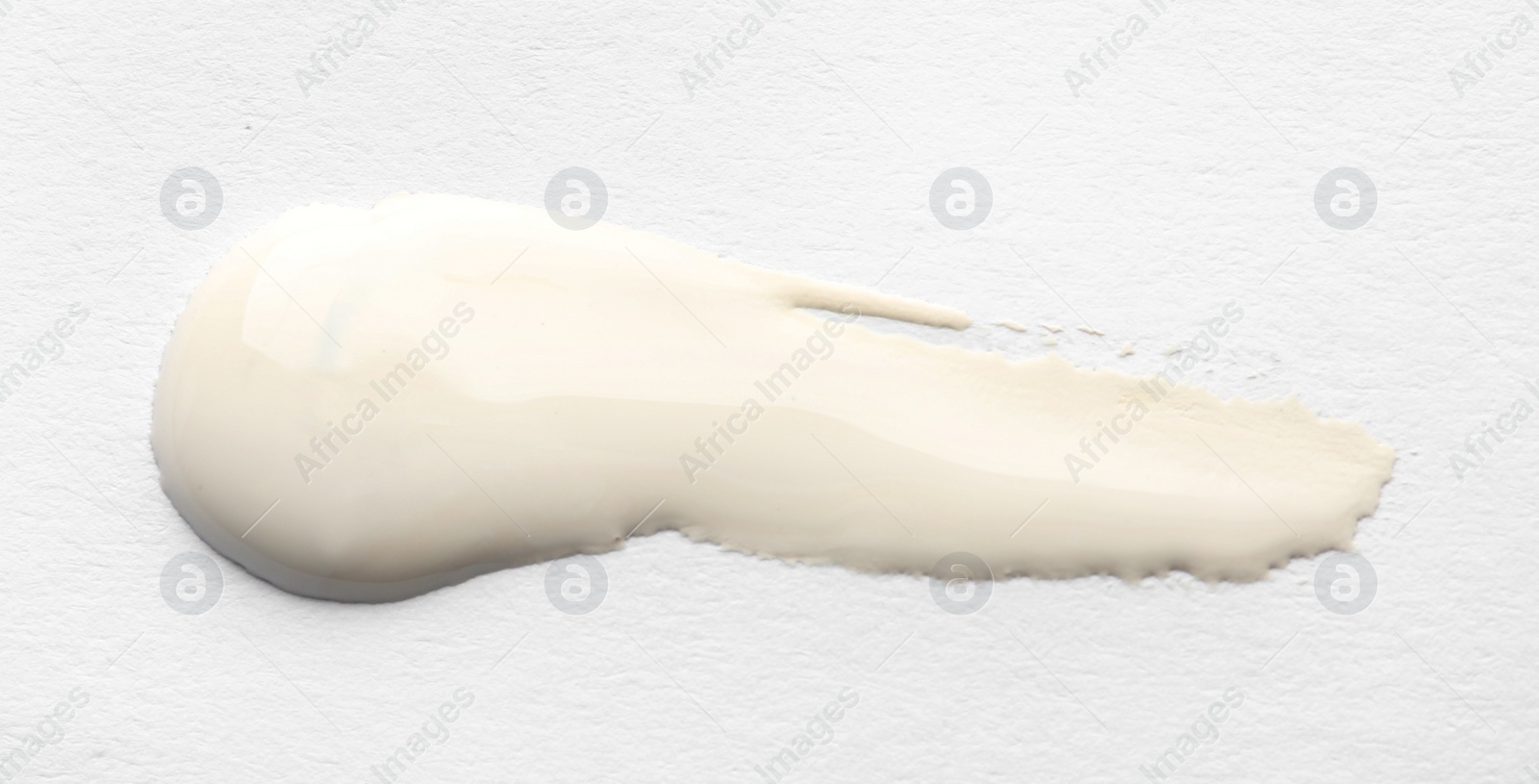 Photo of Abstract brushstroke of white paint isolated on white