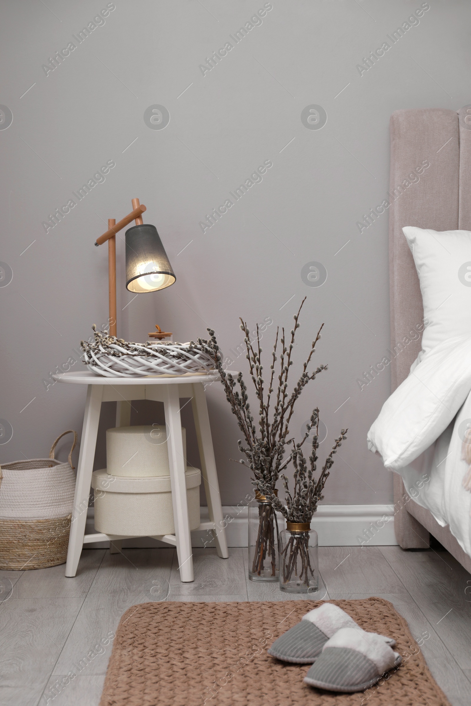Photo of Bedroom interior with pussy willow branches and other decor