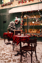 Photo of Beautiful outdoor cafe with festive decoration. Christmas celebration