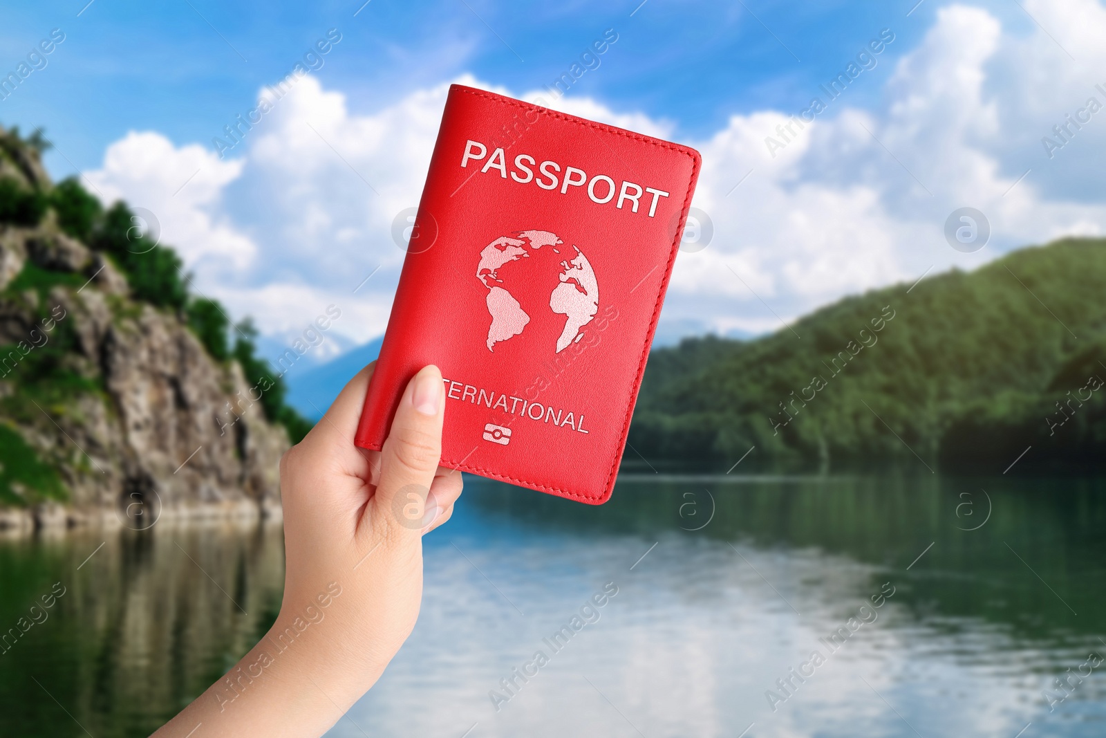 Image of Woman holding international passport and beautiful view of lake on background