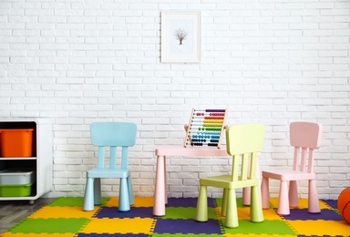 Photo of Stylish playroom interior with toys and modern furniture