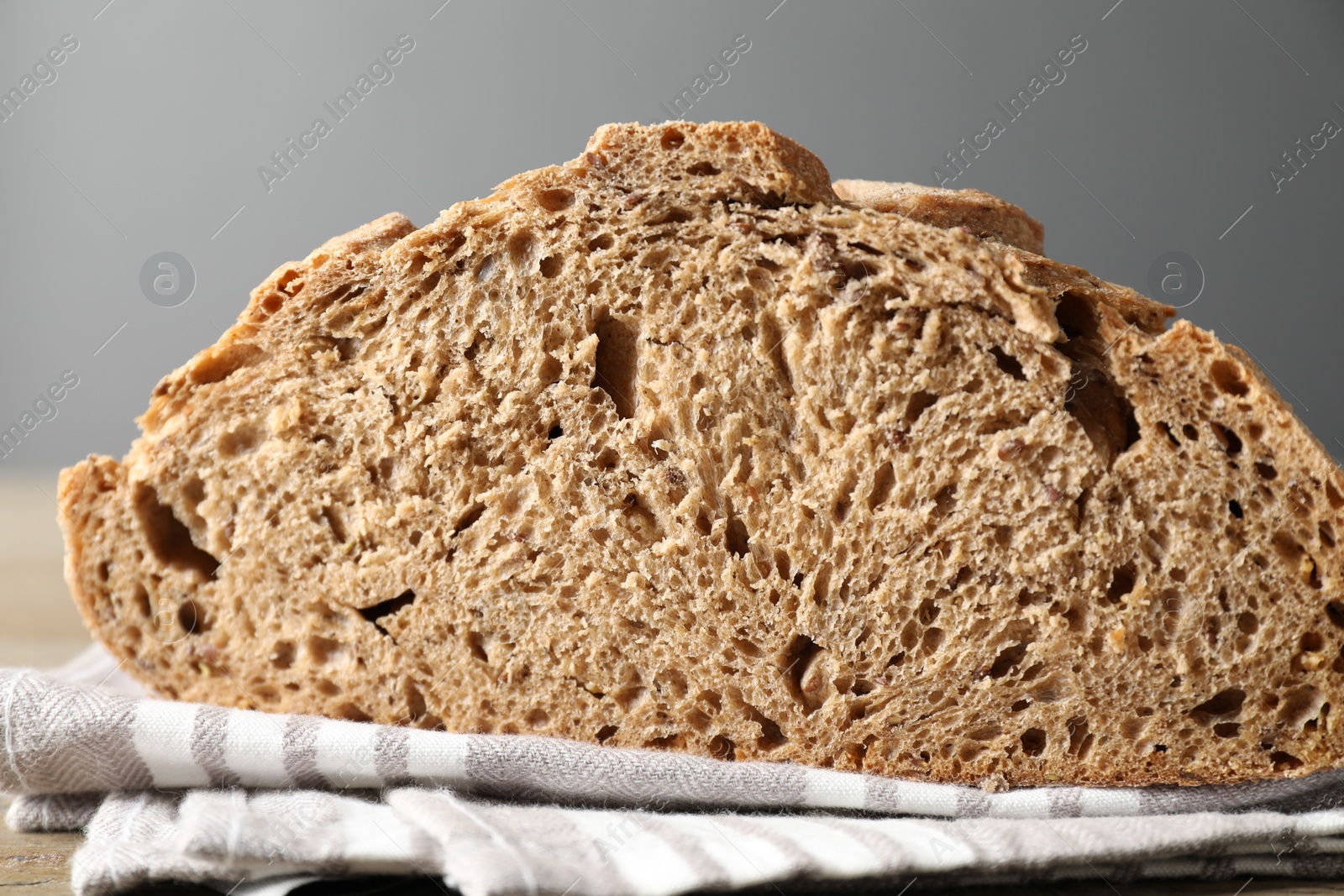 Photo of Freshly baked sourdough bread on wooden table, closeup