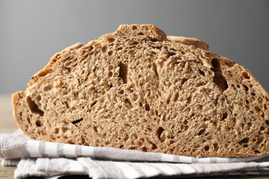 Freshly baked sourdough bread on wooden table, closeup