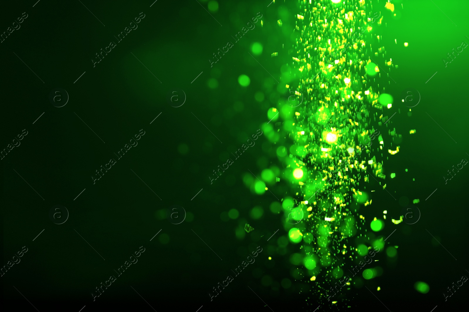 Image of St. Patrick day. Shiny green glitter on black background, bokeh effect