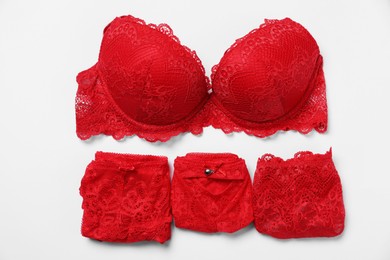 Photo of Stylish red women's underwear on white background, flat lay