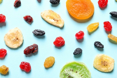 Flat lay composition with different dried fruits on color background. Healthy lifestyle