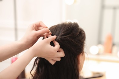 Photo of Hair styling. Professional hairdresser working with client indoors, closeup