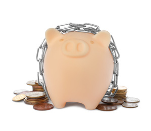 Photo of Piggy bank with steel chain and coins isolated on white. Money safety concept