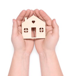 Home security concept. Man holding house model on white background, top view