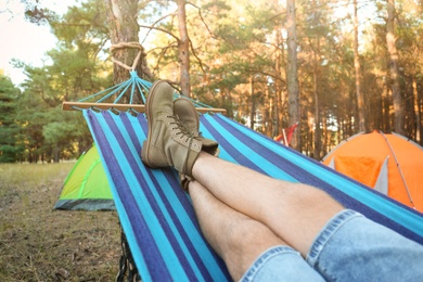 Photo of Man resting in comfortable hammock outdoors, closeup